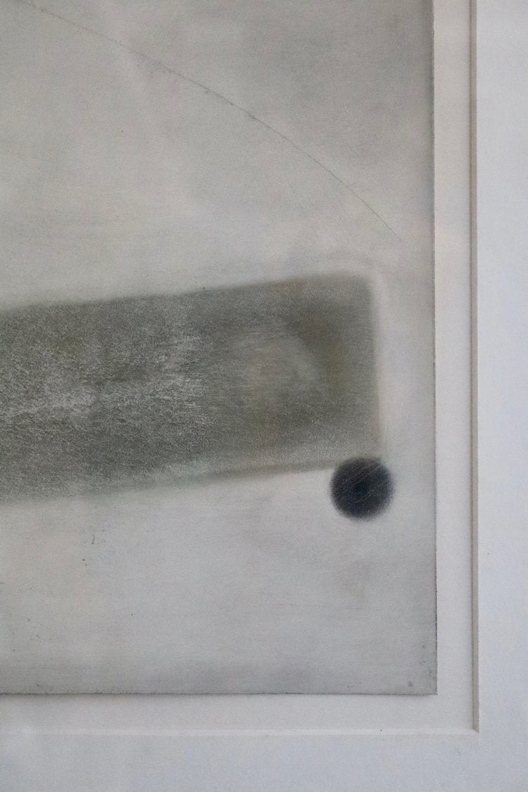 Close-up of a textured surface with a black dot