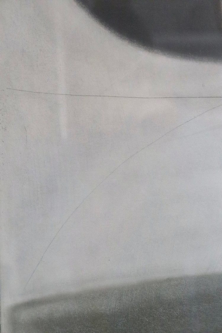 Close-up of a textured gray surface with a black object partially visible