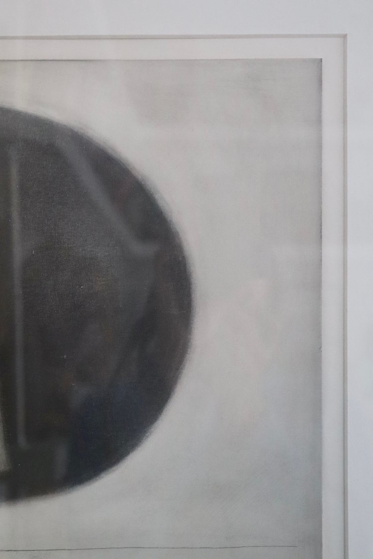Close-up of a textured surface with a circular object on a light gray background