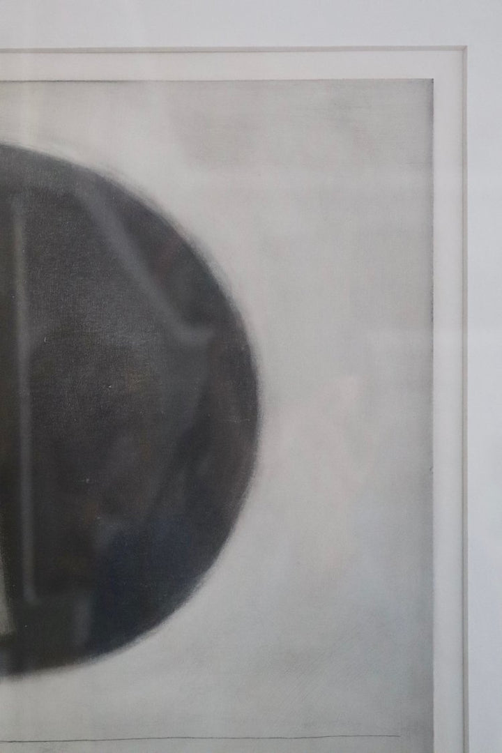 Close-up of a textured surface with a circular object on a light gray background