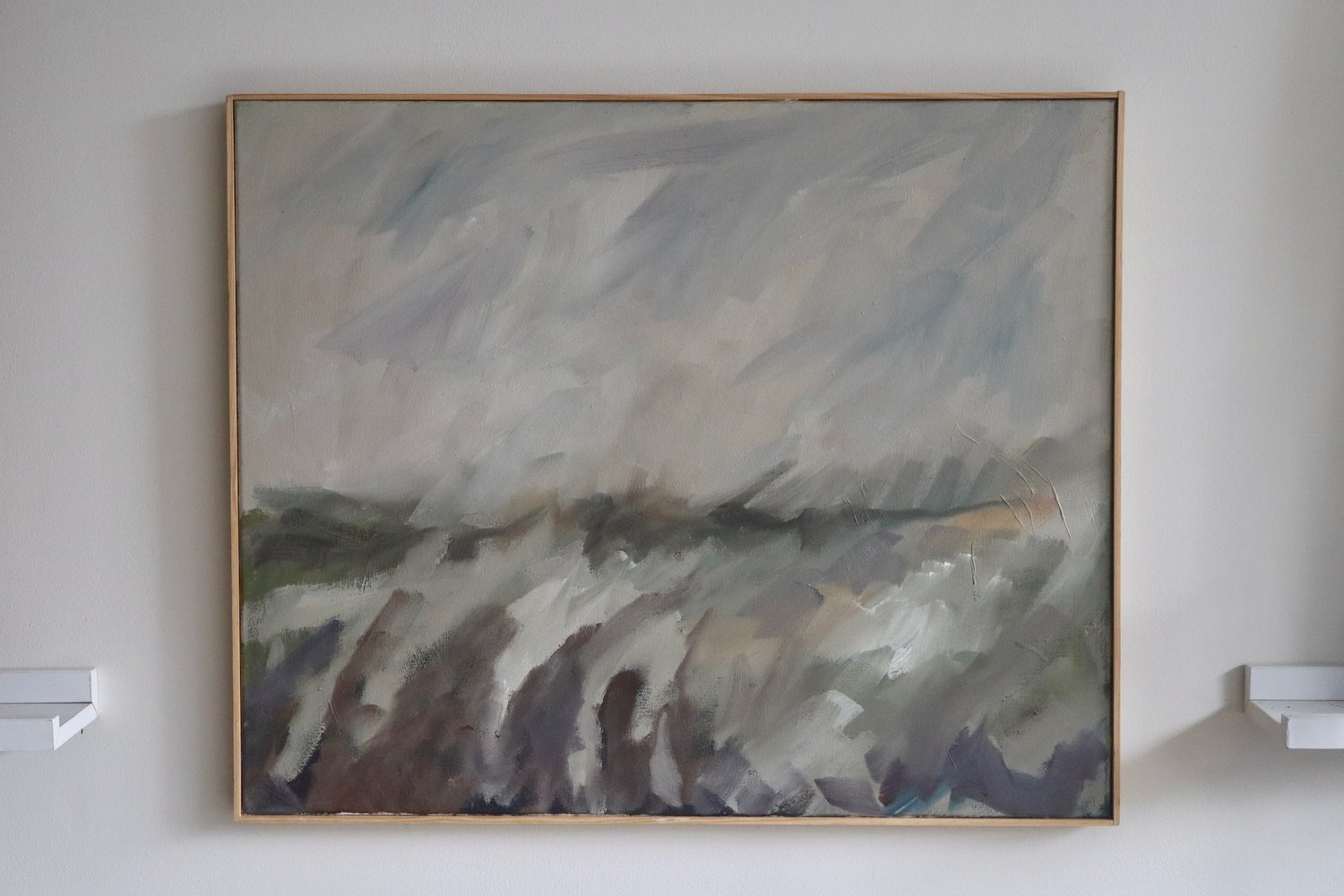 Abstract painting on a wall with a gold frame