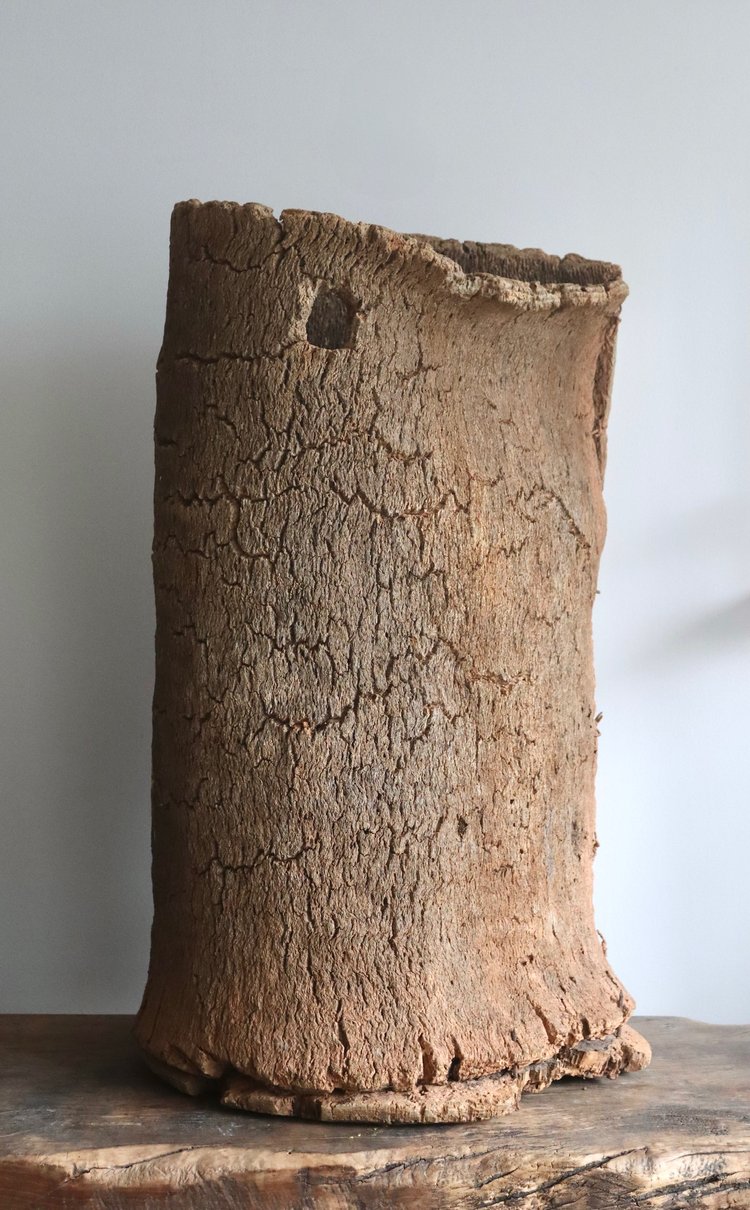 Clay pot with a textured surface on a wooden surface