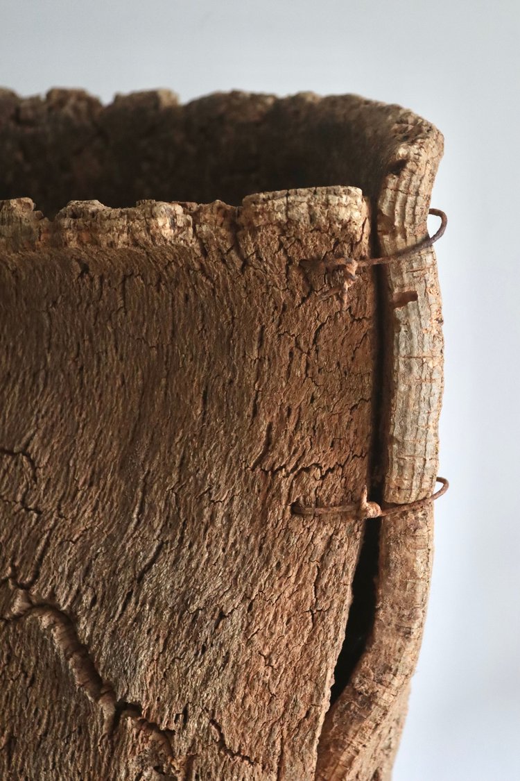 Close-up of a textured brown basket on a light gray background