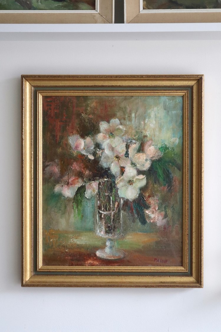 Framed painting of flowers on a white wall