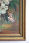 Close-up of a painting with floral elements and a gold frame.