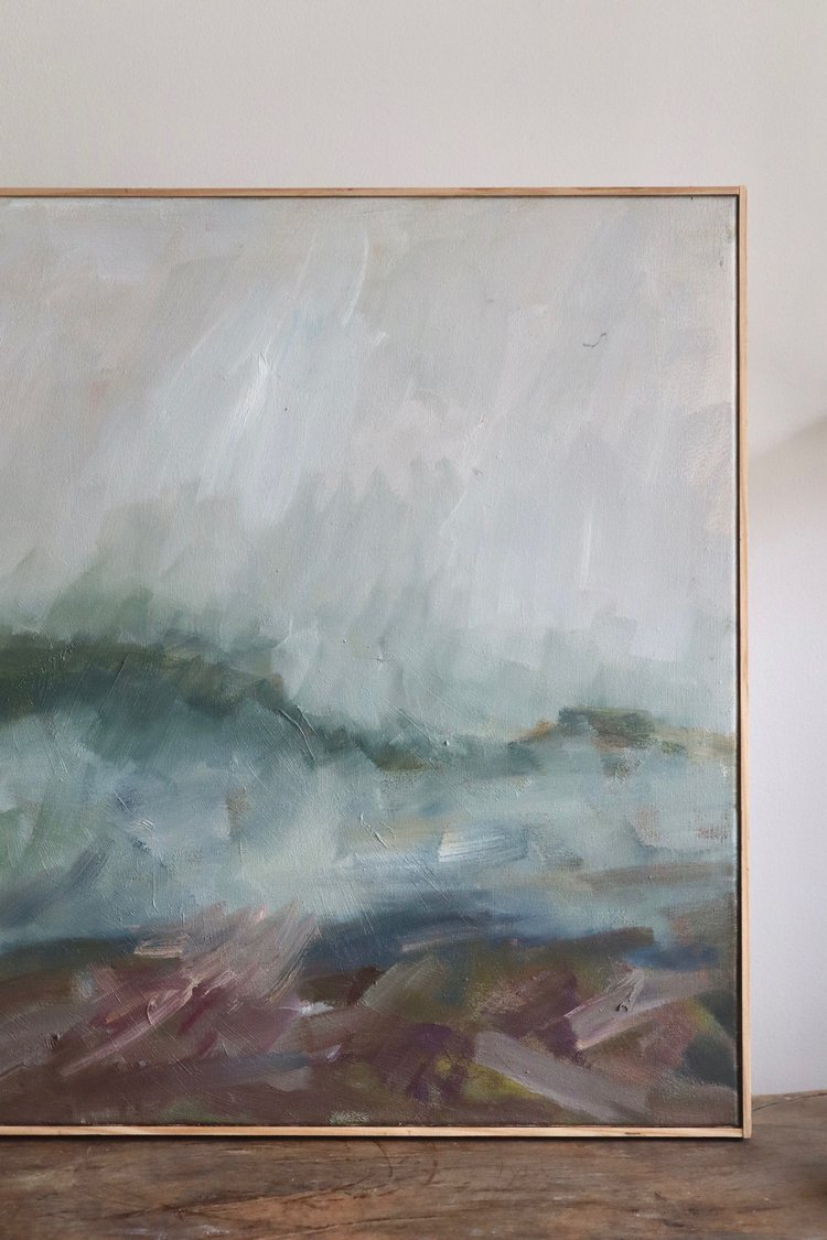 Abstract painting on a wooden surface with a white wall background