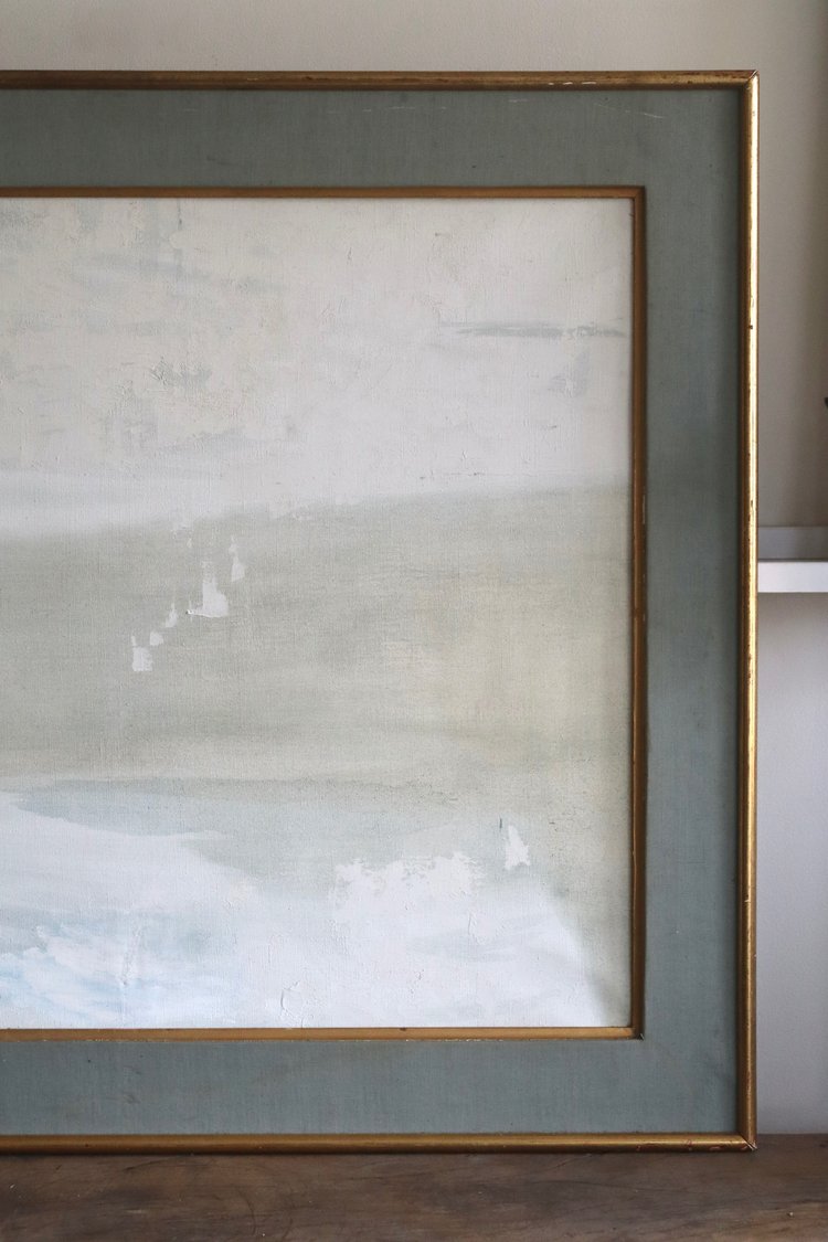 Framed abstract artwork with a gold frame on a neutral background