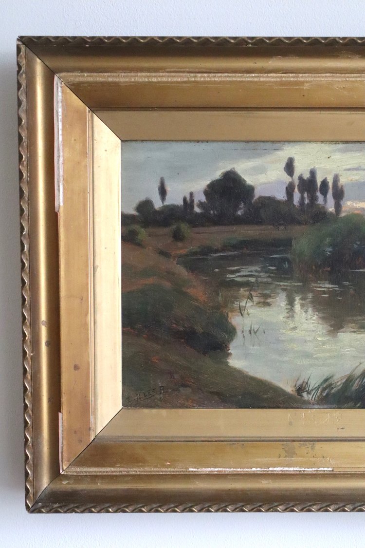 Framed painting of a landscape with a river and trees