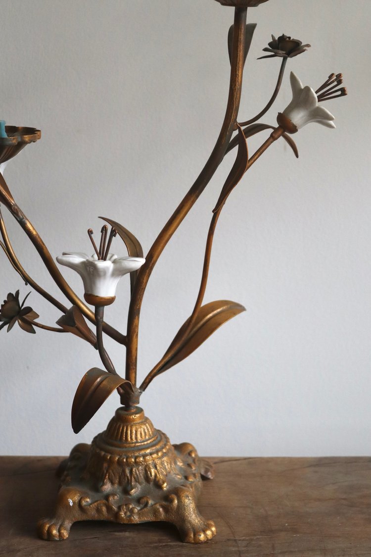 Decorative brass lamp with floral design on a wooden surface