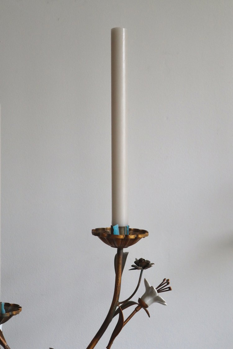 Candle holder with a candle on a plain background