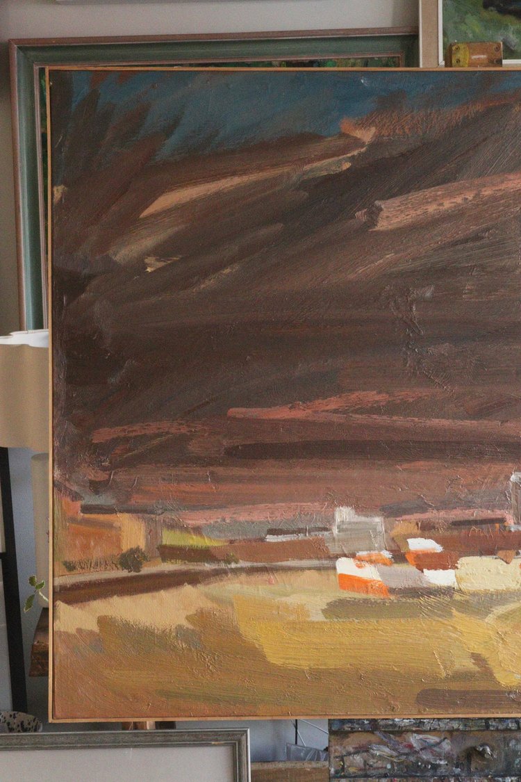 Abstract painting with brown, orange, and green colors on a canvas.