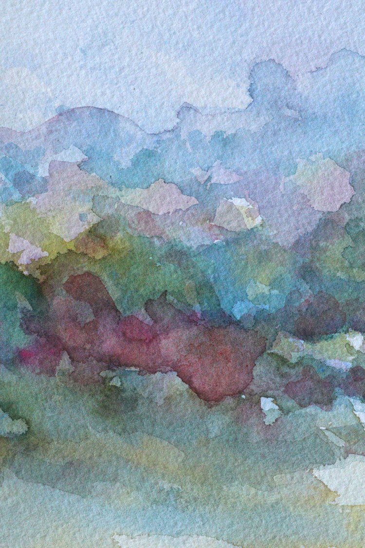 Abstract watercolor painting with soft, blended colors on a light blue background