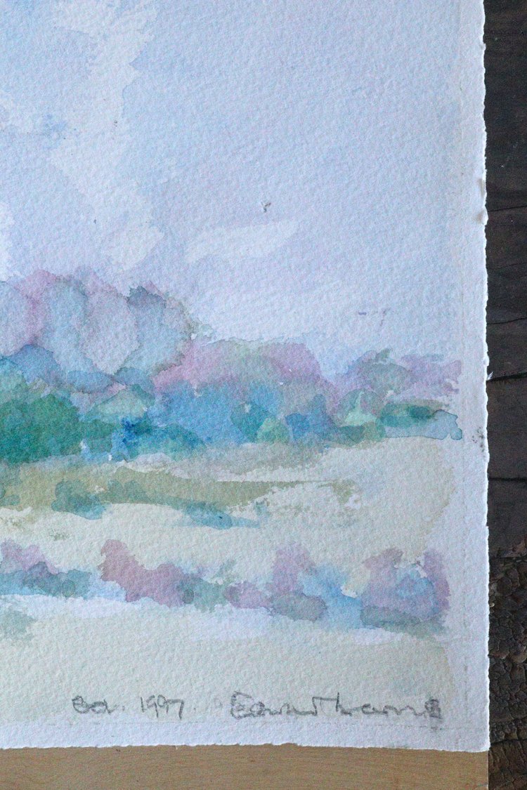 Watercolor landscape painting with pastel colors on textured paper
