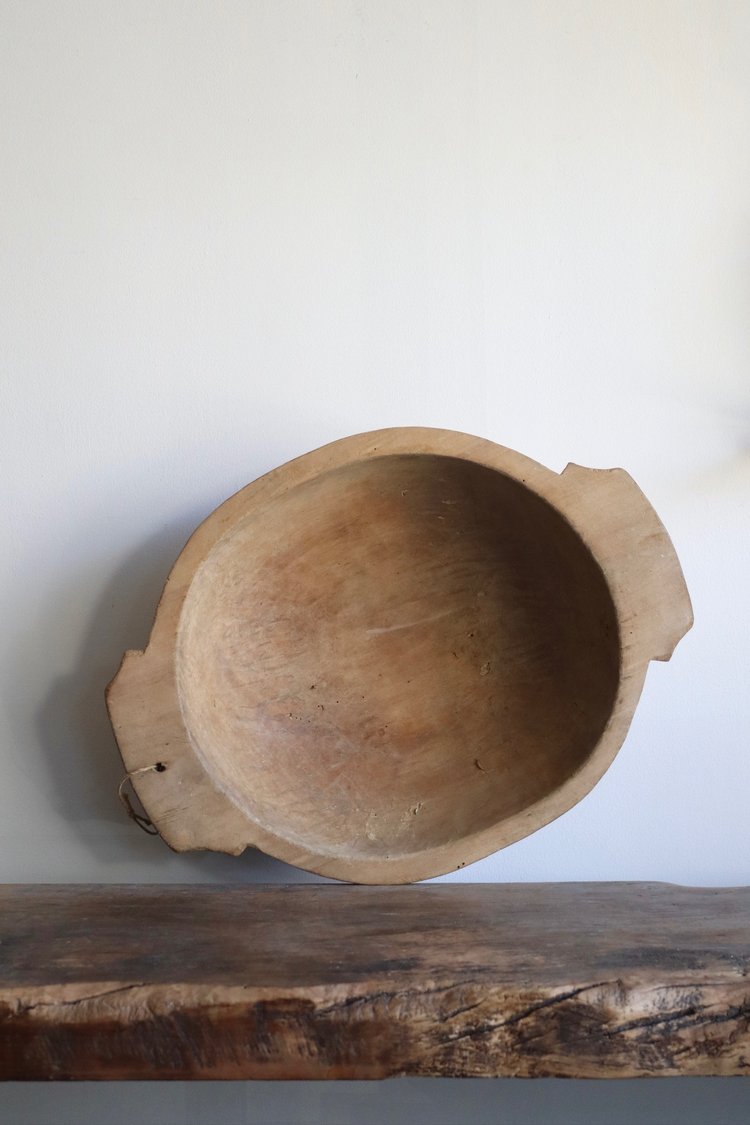 Wooden bowl on a wooden surface with a white background