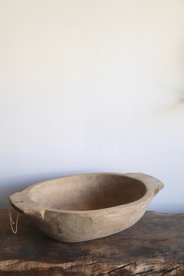 Wooden bowl on a wooden surface with a white background