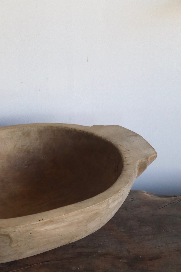 Wooden bowl on a wooden surface with a white background
