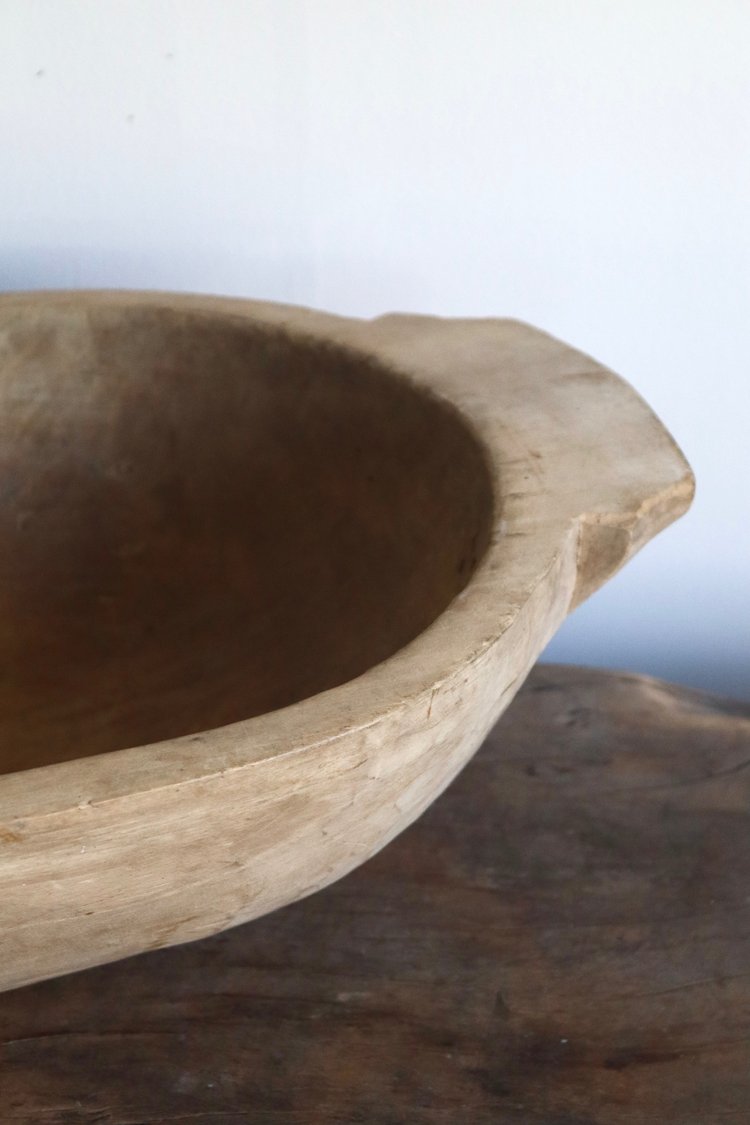 Wooden bowl on a wooden surface with a neutral background