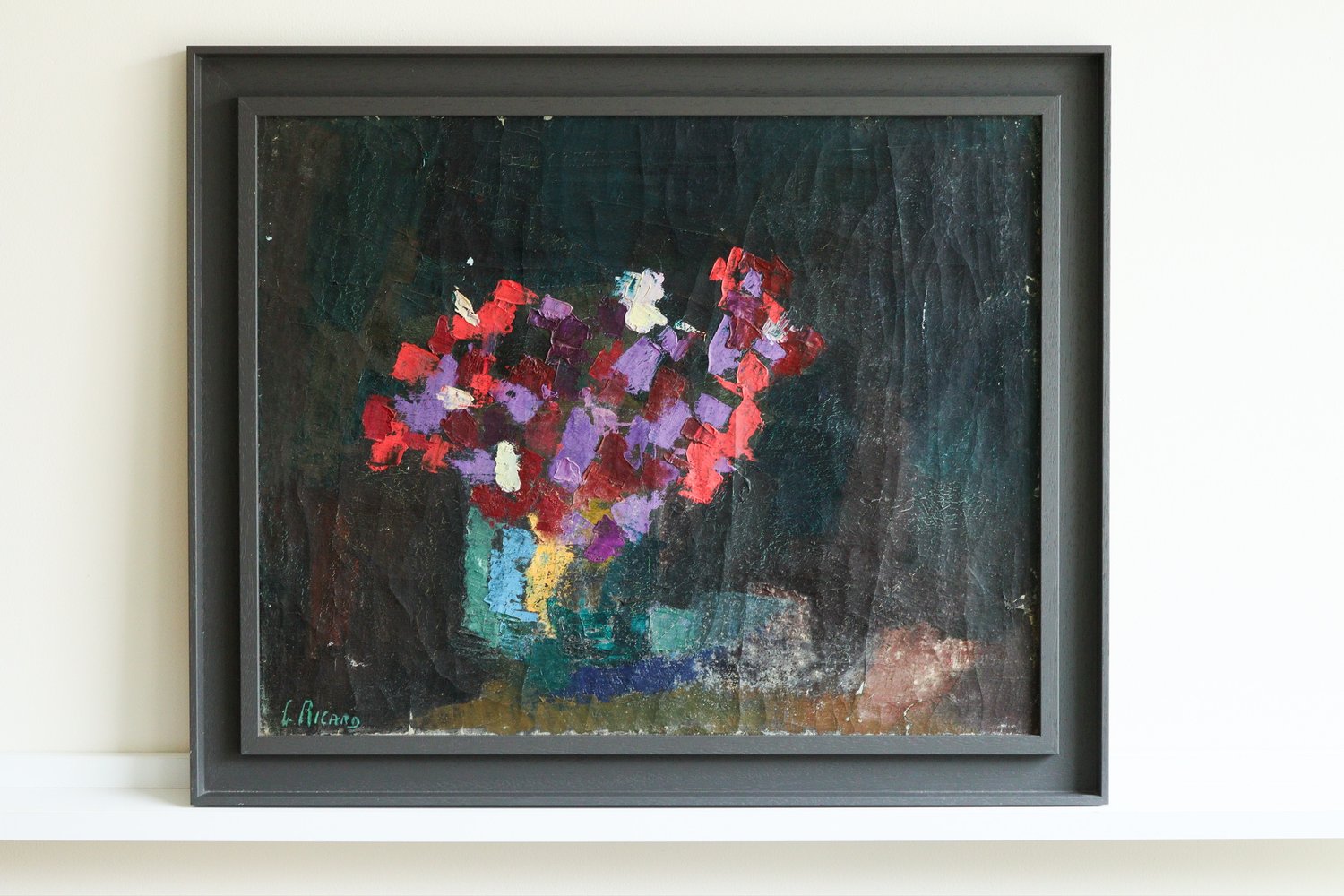 Framed abstract painting with colorful flowers on a dark background