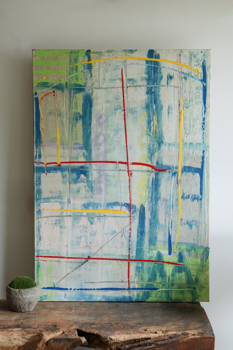 Abstract painting with blue, green, and red lines on a white wall.