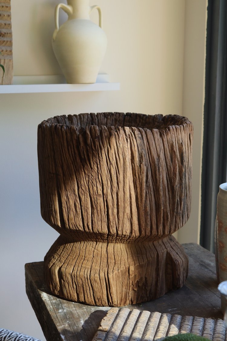Wooden planter on a surface with a blurred background