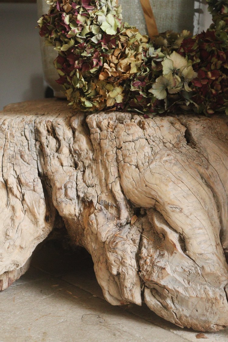Driftwood table with dried hydrangeas on a neutral background