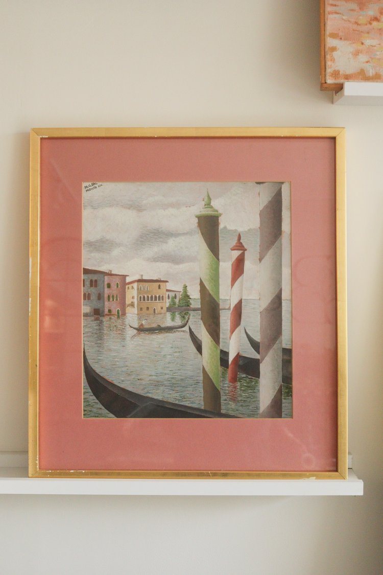 Framed artwork of a Venetian canal scene with a striped lighthouse.