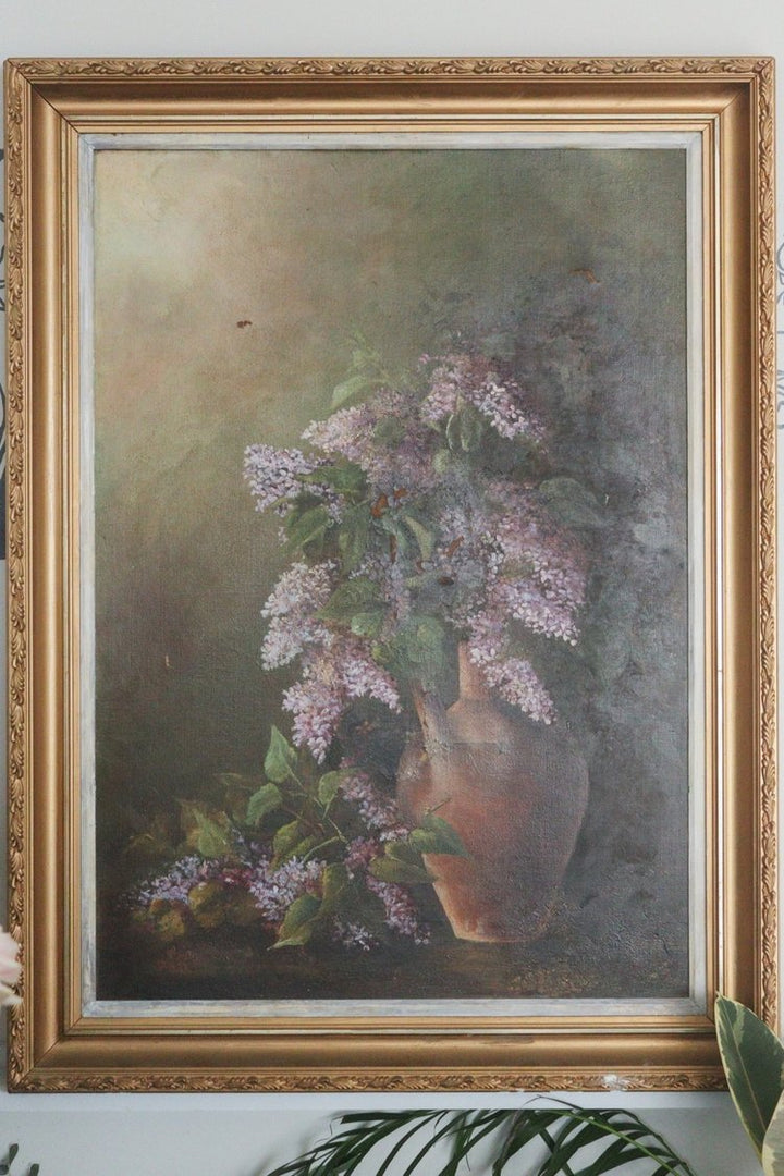 Framed painting of a still life with flowers and a vase on a textured background